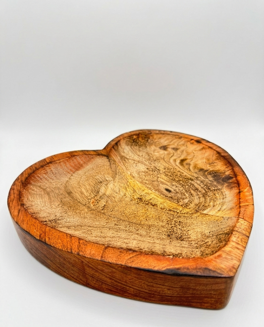 Heart-shaped wooden bowl on a white background